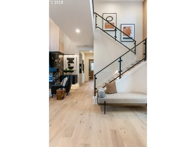 a living room with fireplace furniture and a potted plant
