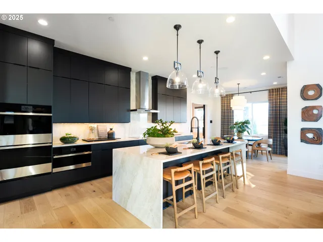 a kitchen with stainless steel appliances kitchen island granite countertop a sink and cabinets