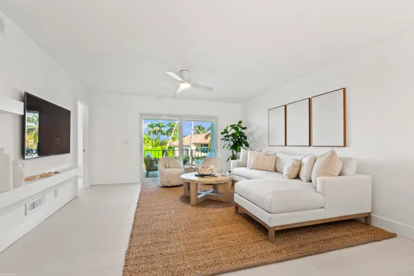 a living room with furniture a couch and a potted plant