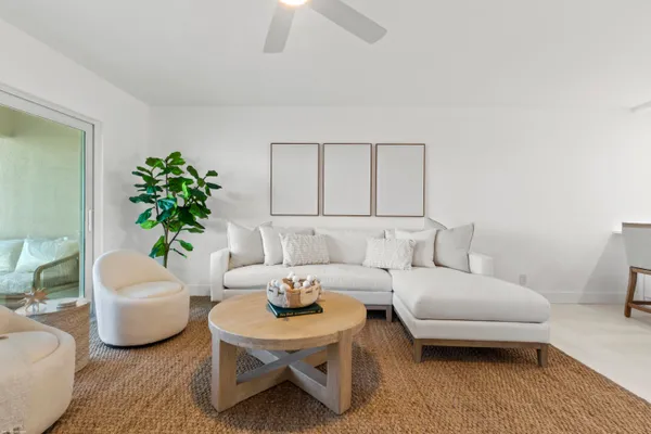 a living room with furniture and a potted plant
