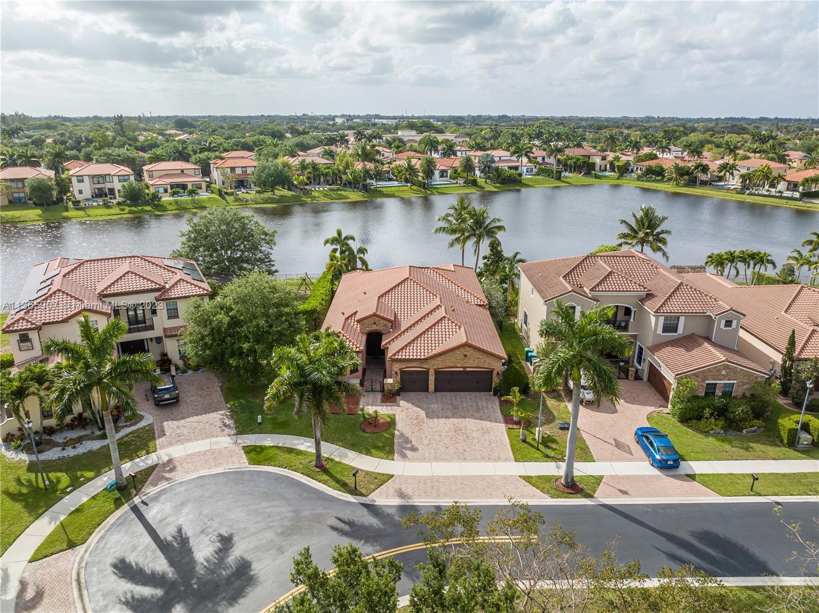 an aerial view of lake and residential houses with outdoor space and ocean view