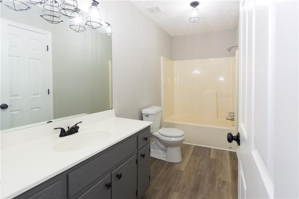 374 McGiboney Road Covington, GA 30016 - Photo 20 of 29 a bathroom with a sink a toilet and shower