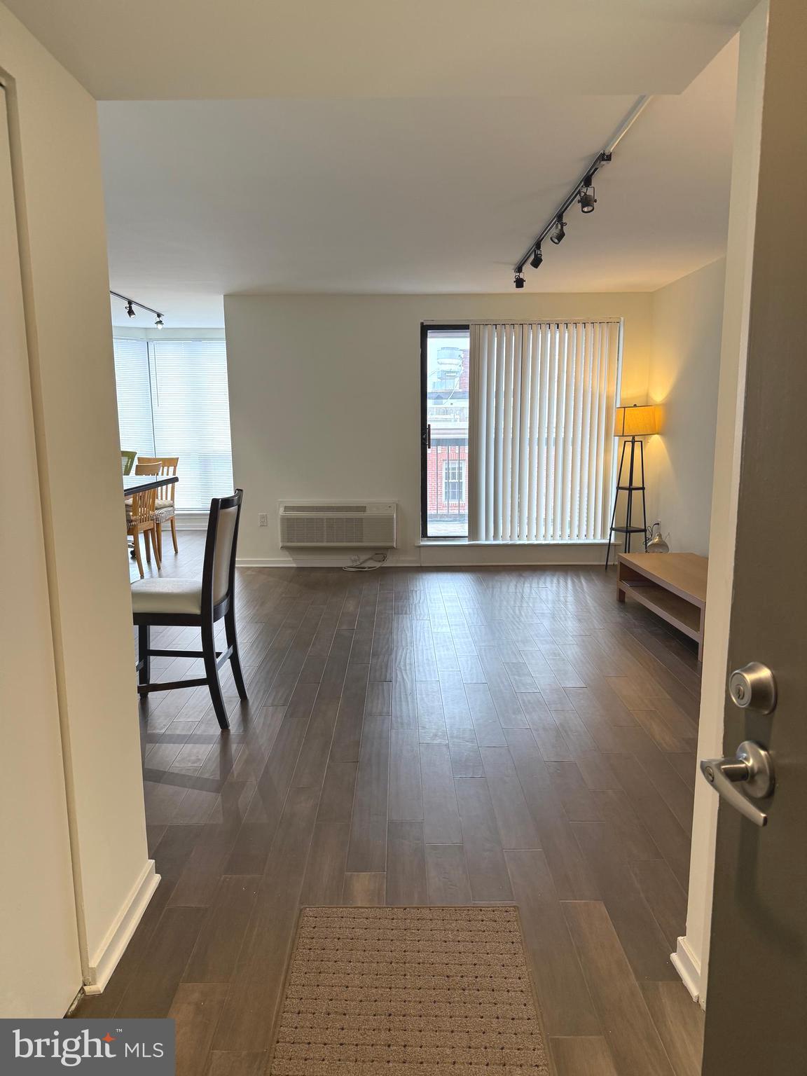 a view of a room with furniture and wooden floor
