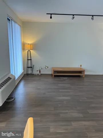 a view of a room with wooden floor