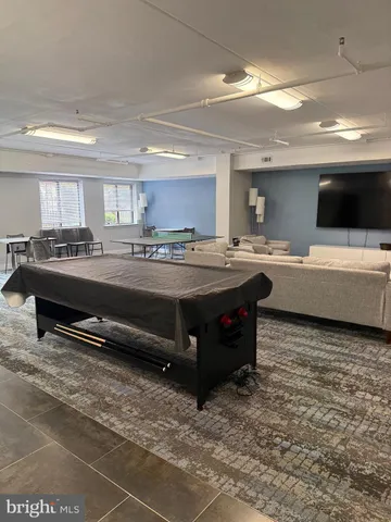 a room with stainless steel appliances kitchen island granite countertop a sink and a stove