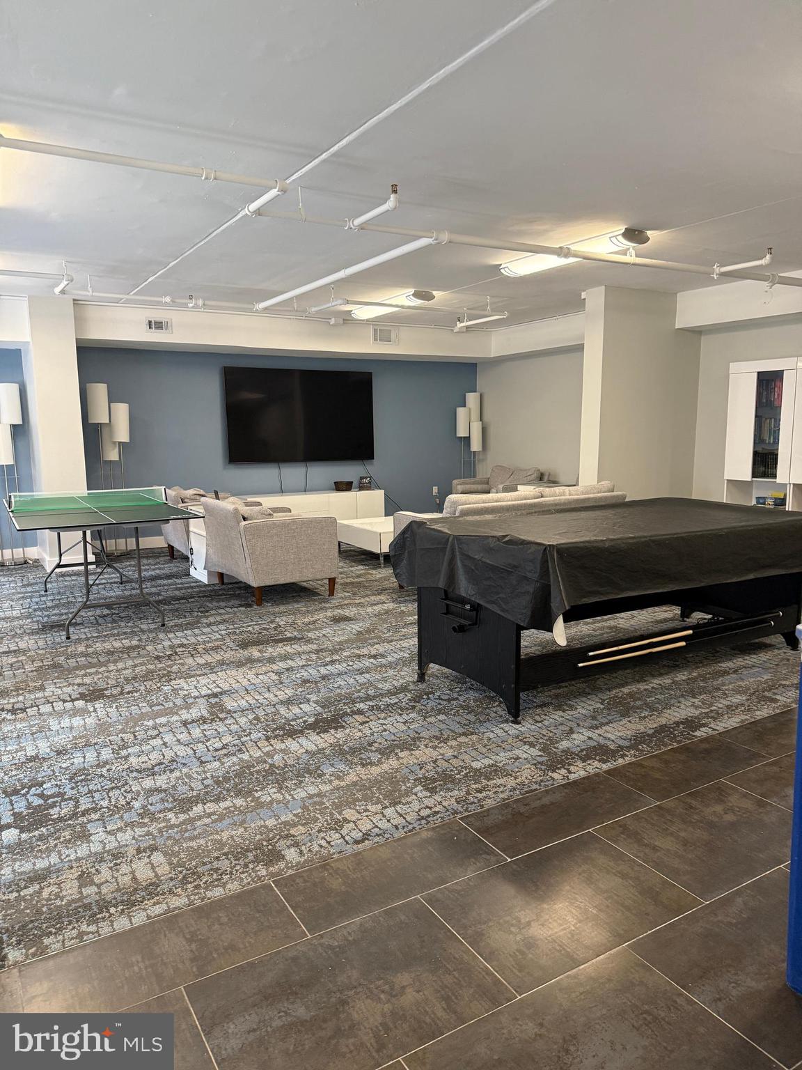 200 Lombard Street, Unit 625 Philadelphia, PA 19147 - Photo 28 of 38 a living room with furniture a flat screen tv and kitchen view