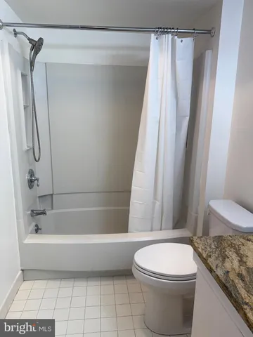 a bathroom with a shower a toilet and a sink