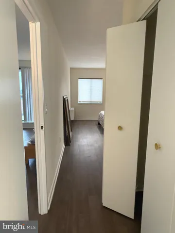 a view of hallway with stairs and wooden floor