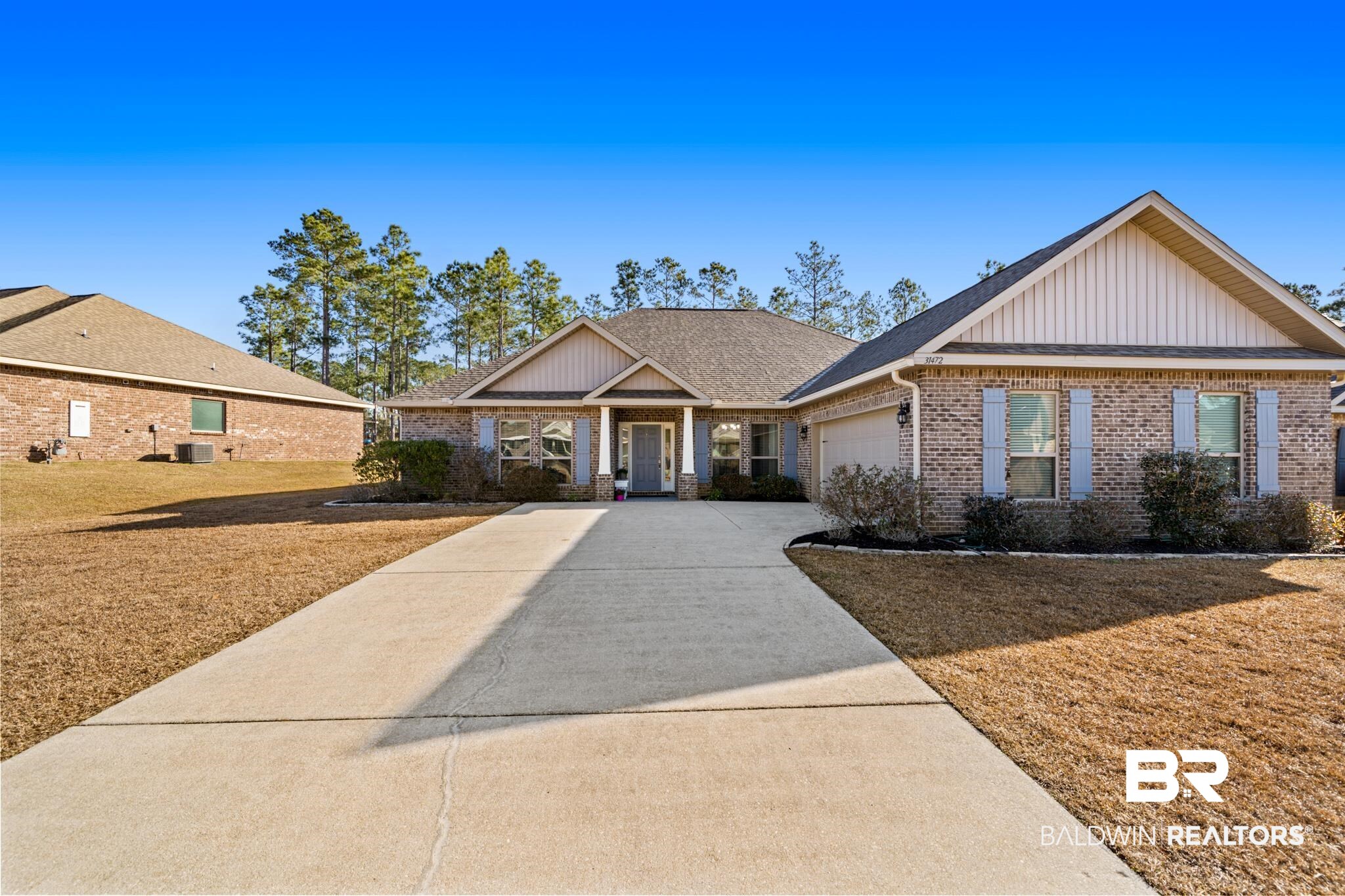 31472 Hoot Owl Road Daphne, AL 36527 - Photo 2 of 32 View of front of house with cooling unit, a front yard, and a garage
