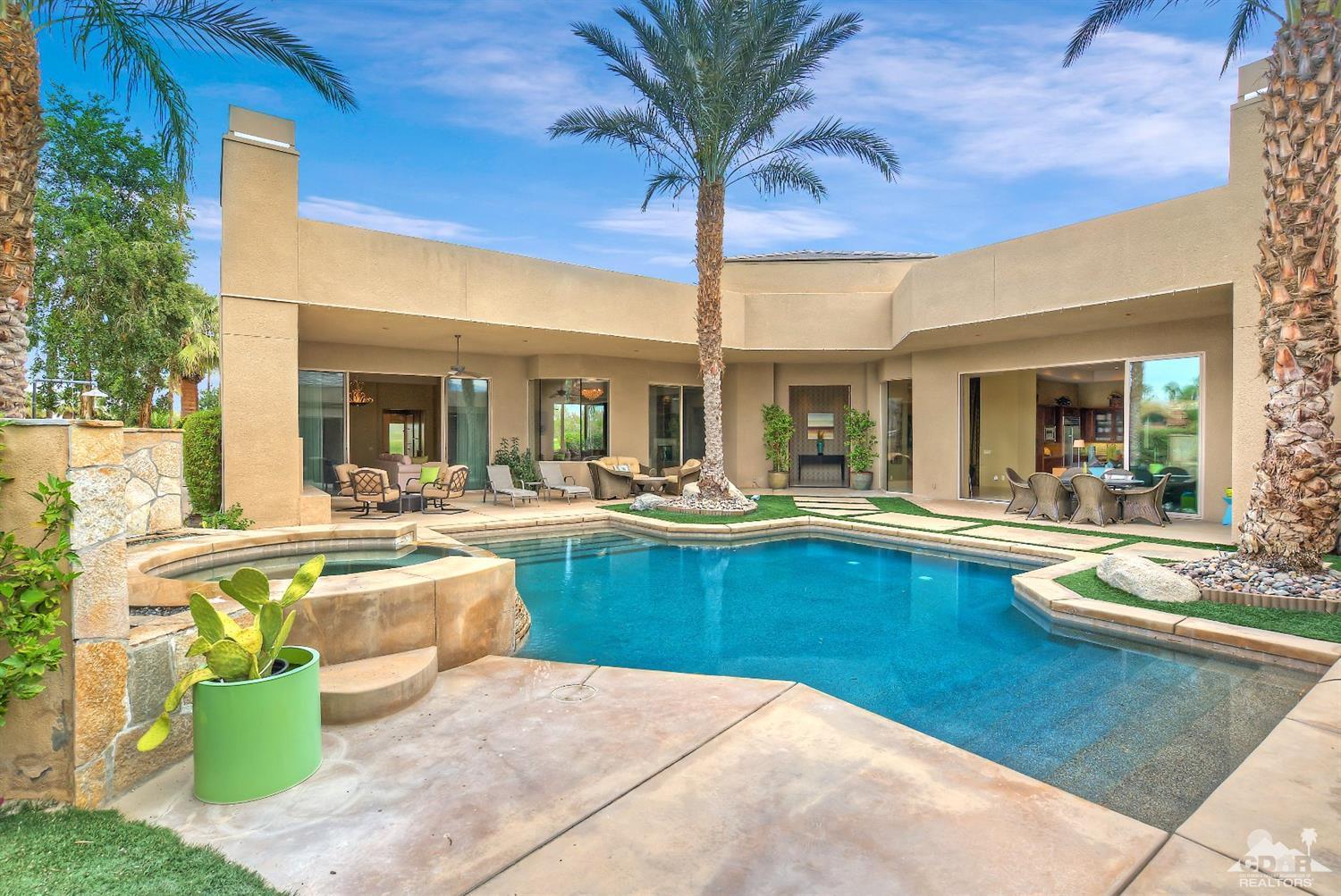 a view of a swimming pool with outdoor seating