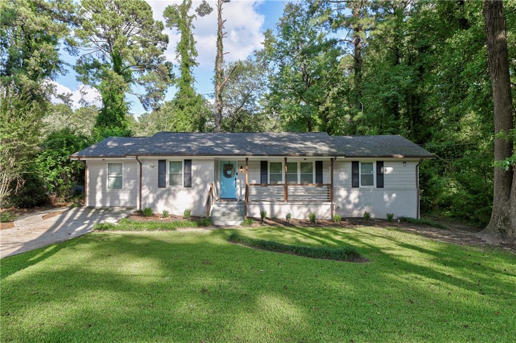 1856 Shamrock Drive Decatur, GA 30032 - Photo 1 of 1 a front view of a house with a garden and trees