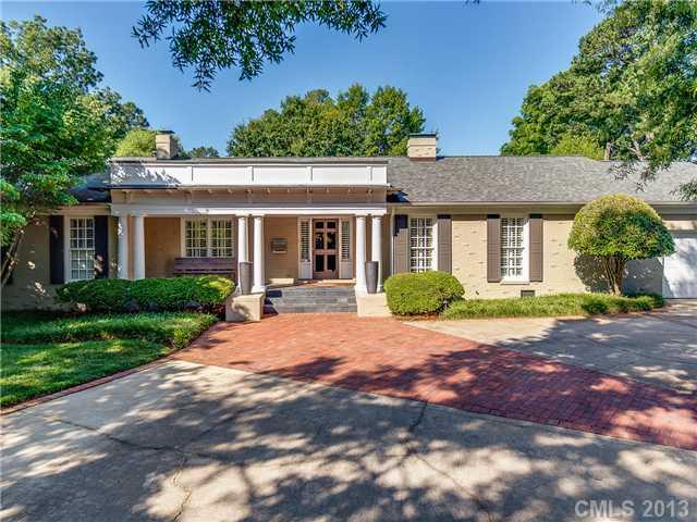 2726 Sharon Road Charlotte, NC 28211 - Photo 1 of 16 a front view of a house with a yard and potted plants