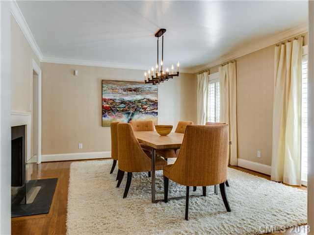 2726 Sharon Road Charlotte, NC 28211 - Photo 3 of 16 a dining room with furniture a chandelier and wooden floor