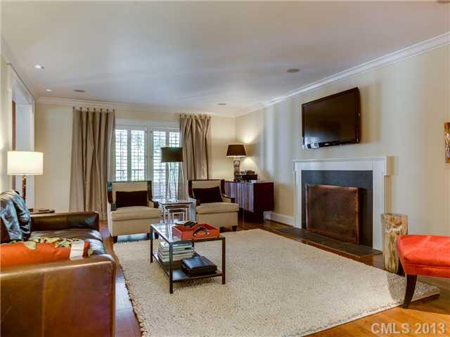 2726 Sharon Road Charlotte, NC 28211 - Photo 4 of 16 a living room with furniture a flat screen tv and a fireplace