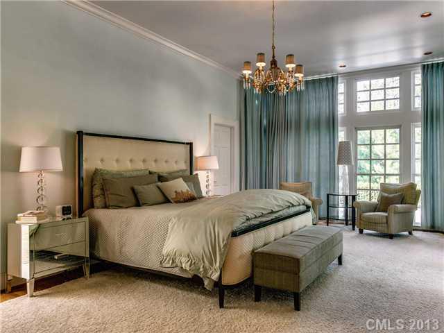 2726 Sharon Road Charlotte, NC 28211 - Photo 6 of 16 a bedroom with a bed and a chandelier