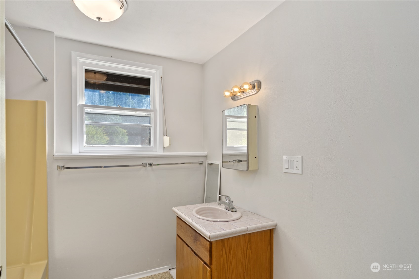 143 Senz Road Sequim, WA 98382 - Photo 27 of 40 a bathroom with a sink a mirror and window