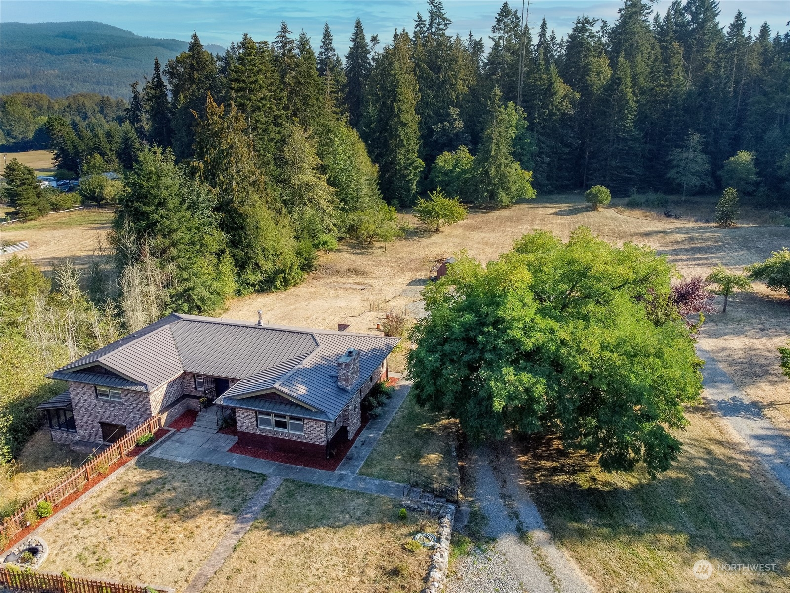143 Senz Road Sequim, WA 98382 - Photo 4 of 40 a view of a backyard with plants and lake view