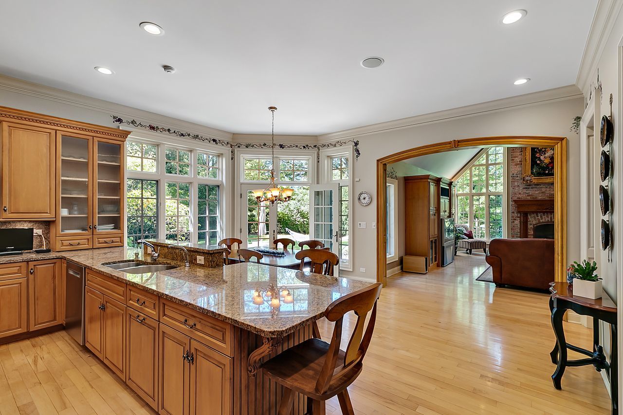1130 Glenview Road Glenview, IL 60025 - Photo 13 of 66 a very nice looking kitchen with granite countertop a stove a sink a dining table and chairs