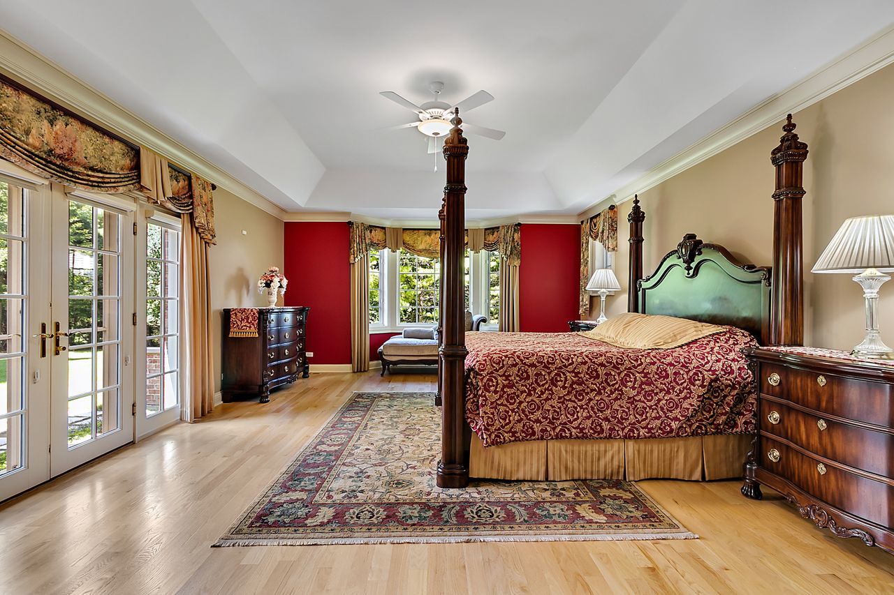 1130 Glenview Road Glenview, IL 60025 - Photo 30 of 66 a bedroom with a large bed and a chandelier