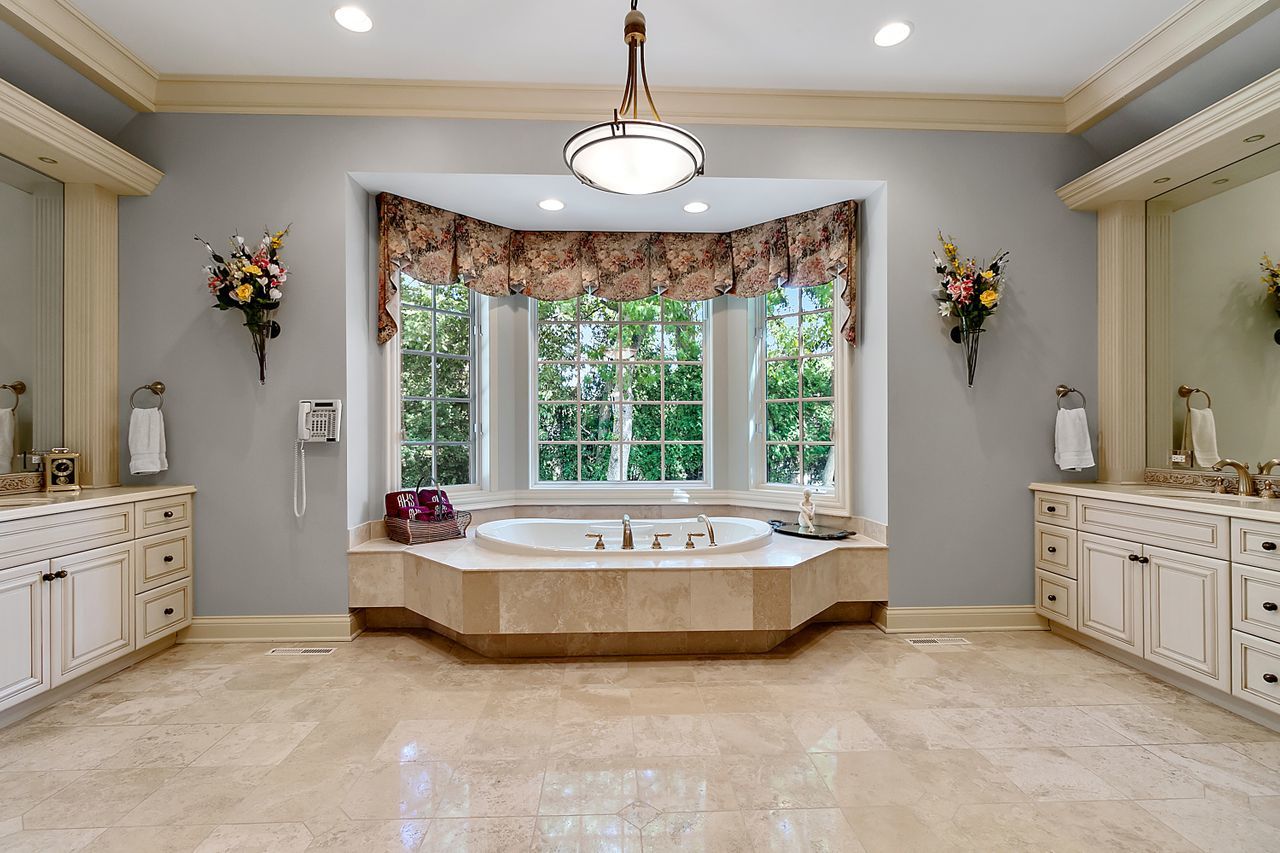 1130 Glenview Road Glenview, IL 60025 - Photo 32 of 66 a spacious bedroom with a bed and a large window