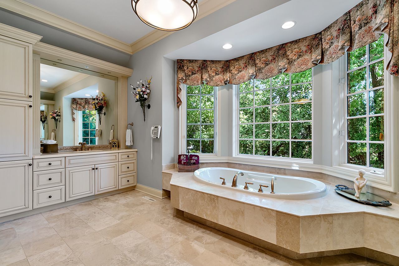 1130 Glenview Road Glenview, IL 60025 - Photo 33 of 66 a spacious bathroom with a granite countertop tub and a large window