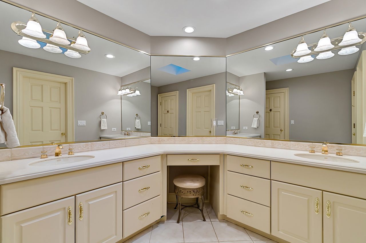 1130 Glenview Road Glenview, IL 60025 - Photo 39 of 66 a spacious bathroom with a granite countertop sink a toilet and a mirror