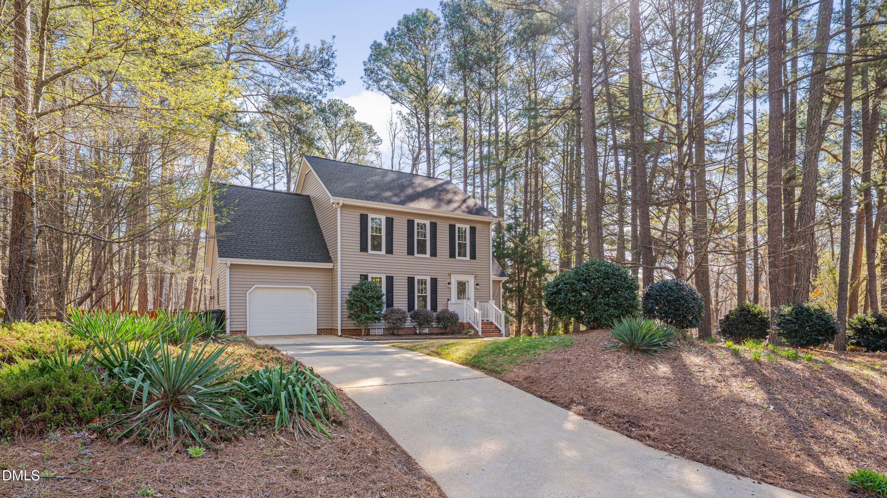 7900 Kingsland Drive Raleigh, NC 27613 - Photo 2 of 32 a front view of a house with a yard and trees