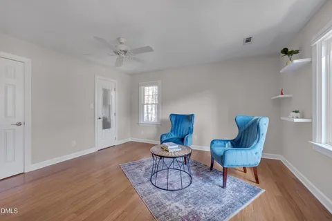 a living room with furniture and a wooden floor