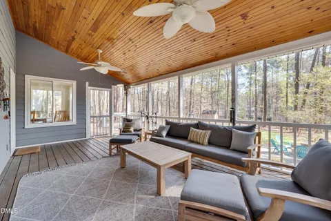 a living room with furniture and large windows