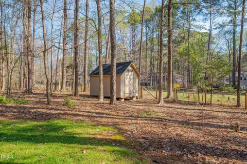a view of a house with a yard and the trees