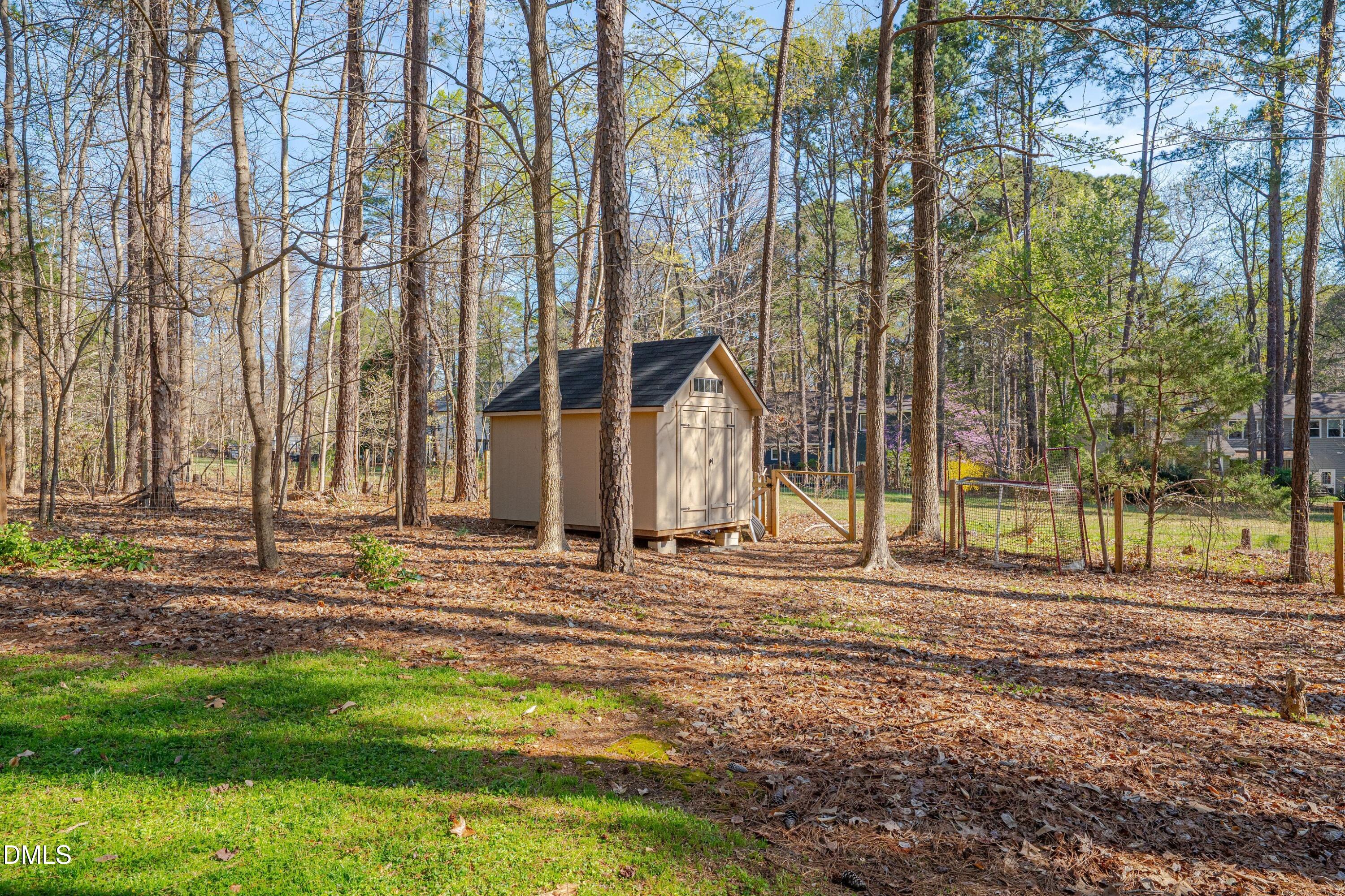 7900 Kingsland Drive Raleigh, NC 27613 - Photo 30 of 32 a view of a house with a yard and the trees