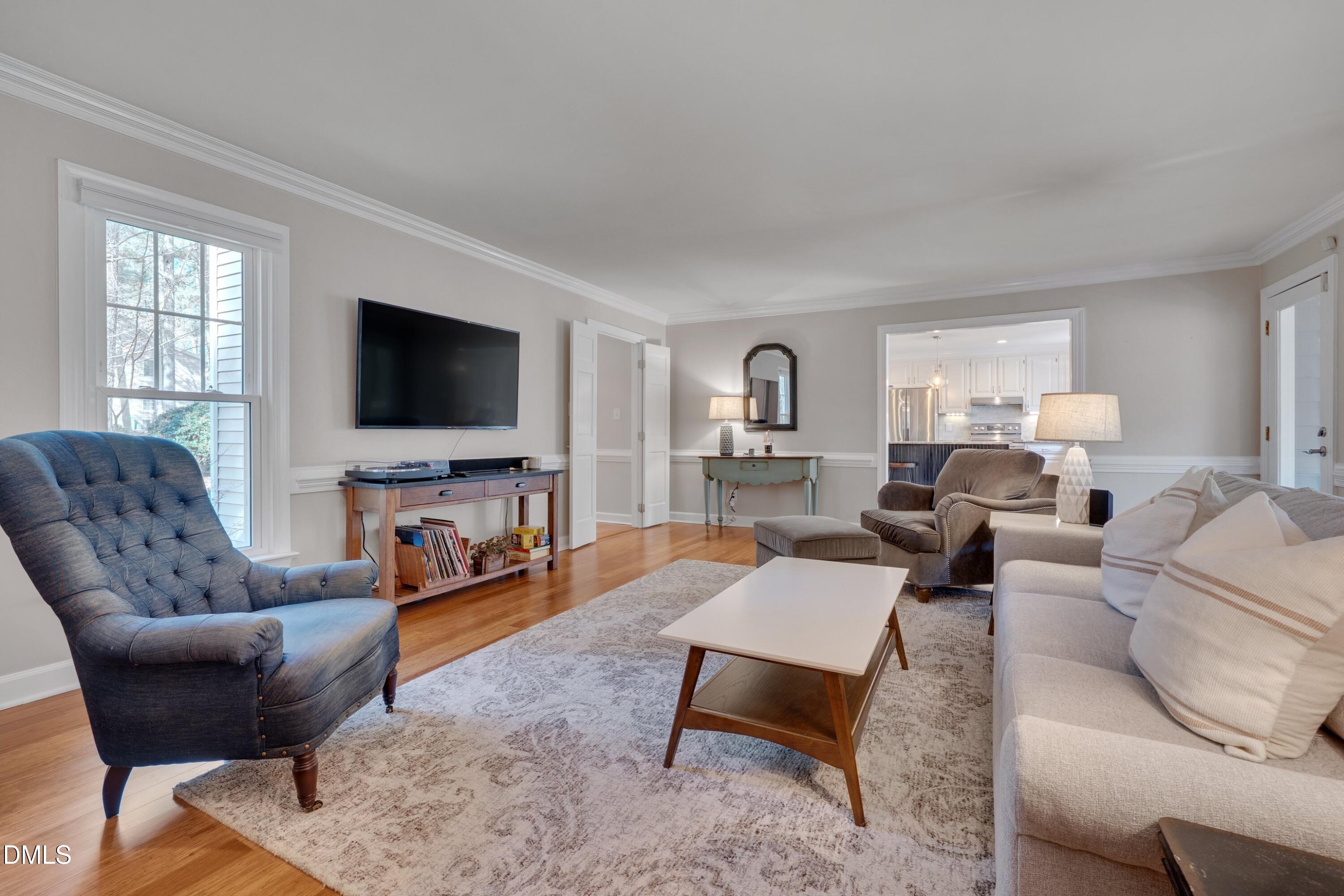 7900 Kingsland Drive Raleigh, NC 27613 - Photo 5 of 32 a living room with furniture and a flat screen tv