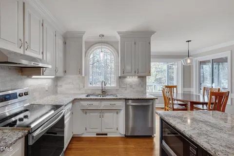 a kitchen with stainless steel appliances granite countertop a stove and a sink