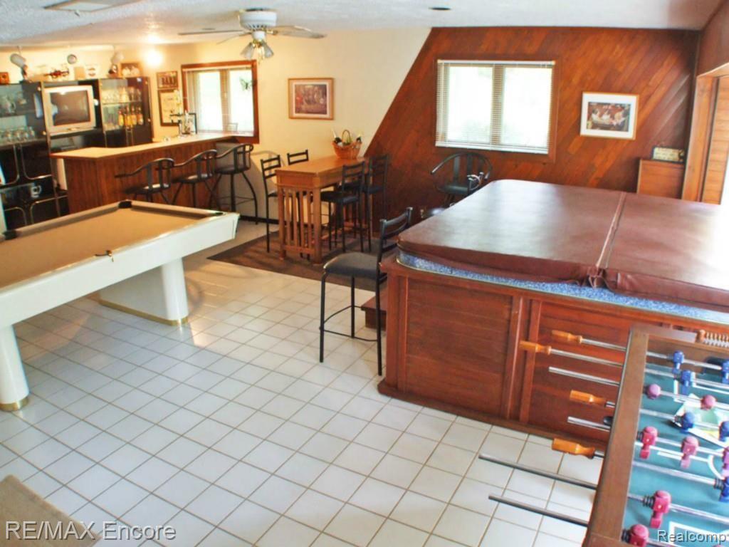 9965 Bridge Lake Road Clarkston, MI 48348 - Photo 11 of 34 Recreation room complete with hot tub and patio doors to outside