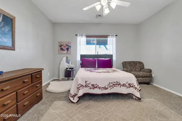 a bedroom with a bed and a dresser