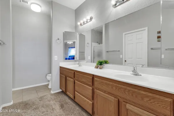 a spacious bathroom with a double vanity sink and a mirror
