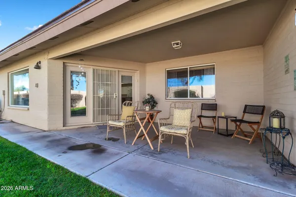 a view of a house with backyard porch and sitting area
