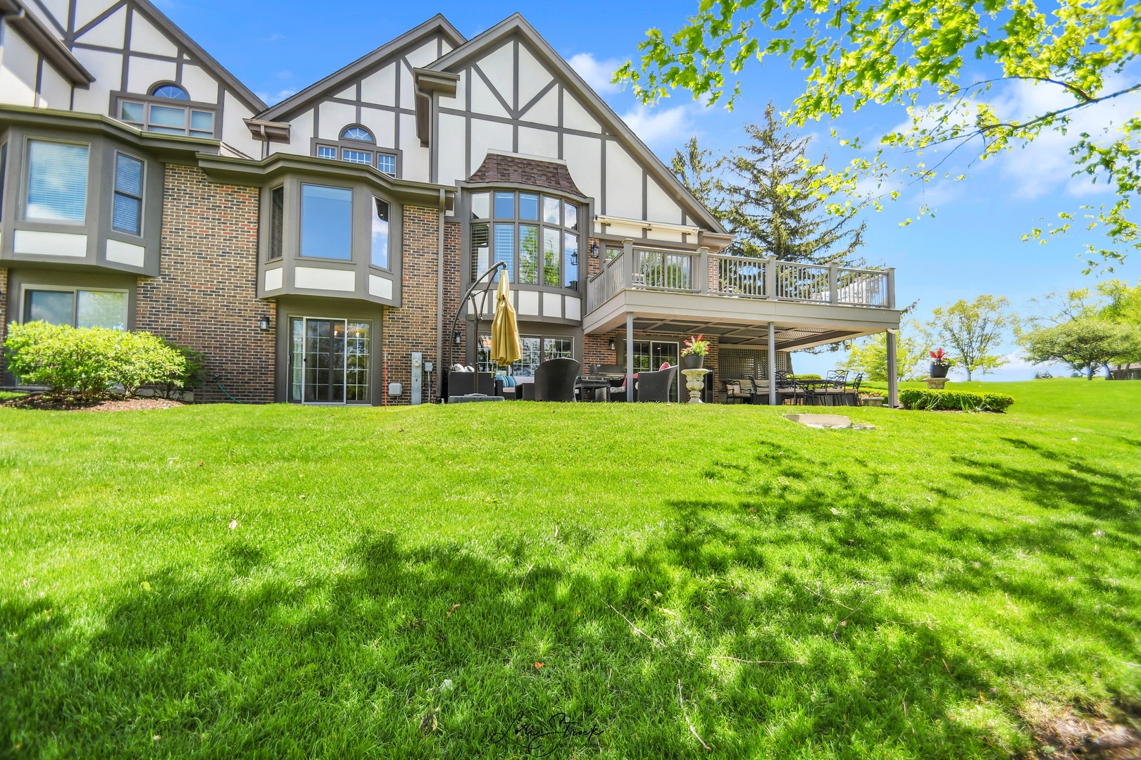 14406 Lake Ridge Road Orland Park, IL 60462 - Photo 4 of 35 a view of a white house with a big yard and large trees