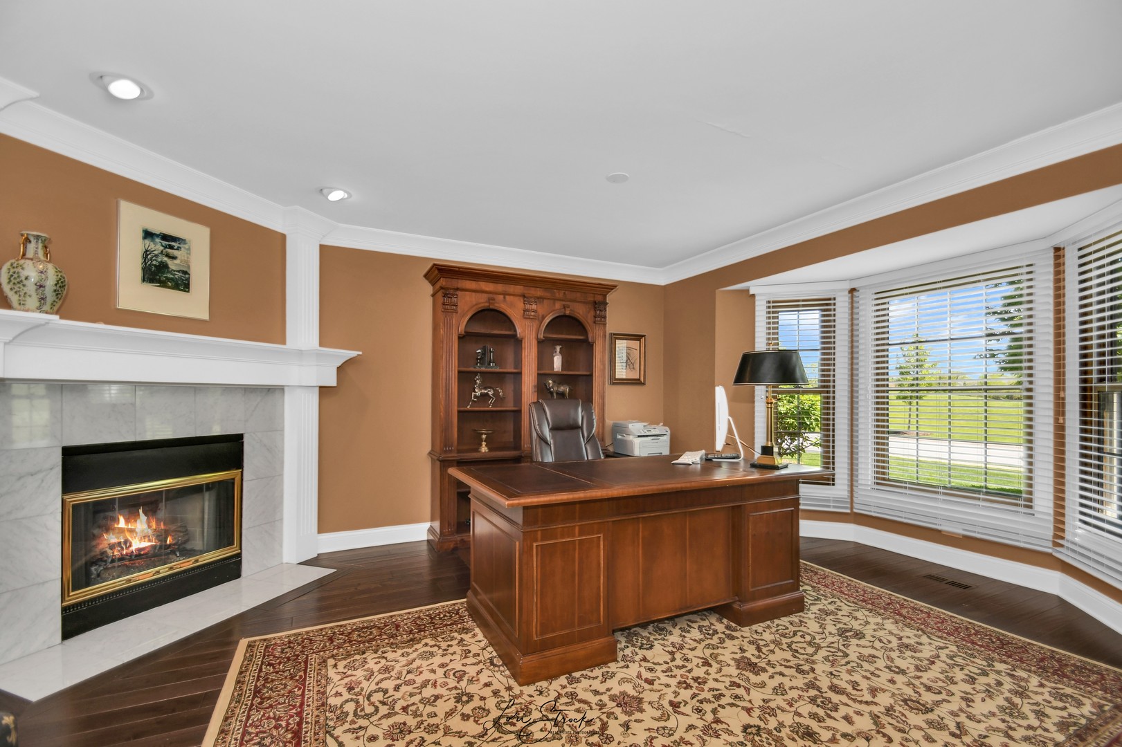 14406 Lake Ridge Road Orland Park, IL 60462 - Photo 9 of 35 a room with a fireplace and a table