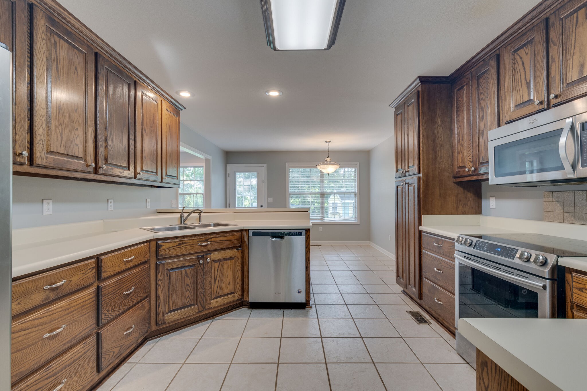 79 Jeans Road Fayetteville, TN 37334 - Photo 16 of 31 a kitchen with stainless steel appliances granite countertop a stove a sink and a microwave
