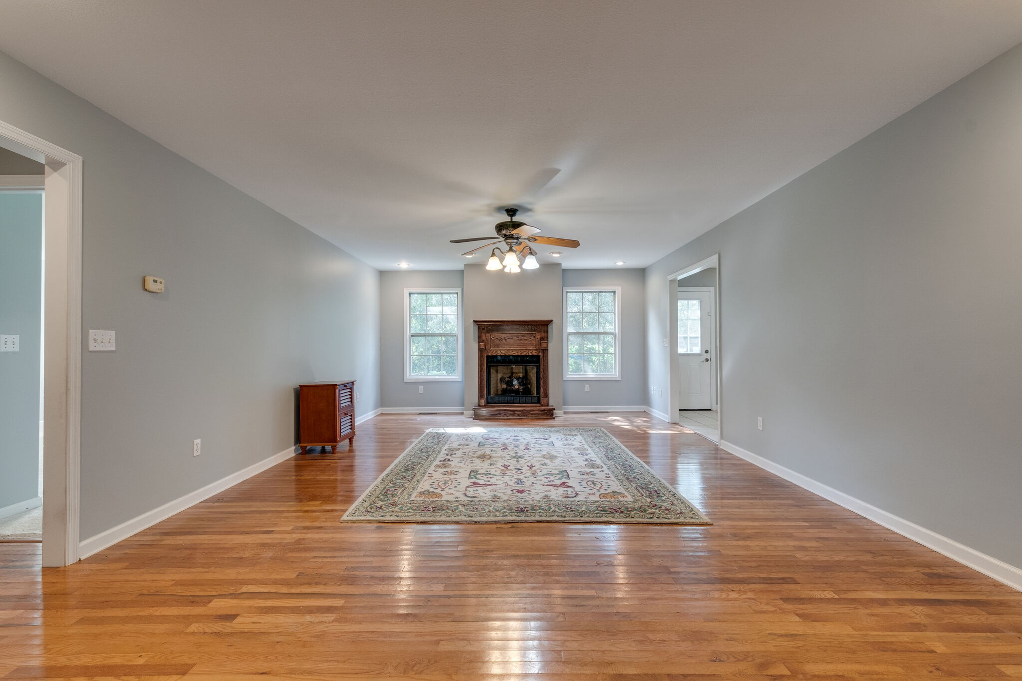 79 Jeans Road Fayetteville, TN 37334 - Photo 10 of 31 a view of a livingroom with a fireplace a chandelier and wooden floor