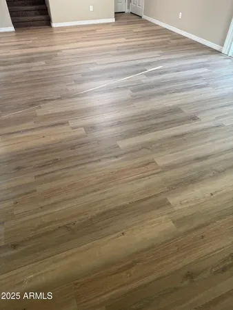 a view of a room with wooden floor