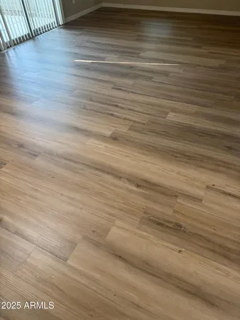 a view of a room with wooden floor