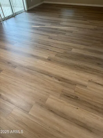 a view of a room with wooden floor