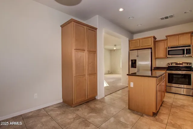 a kitchen with stainless steel appliances a refrigerator and a stove
