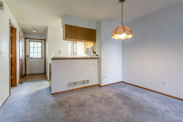 a dining room with furniture a chandelier and wooden floor