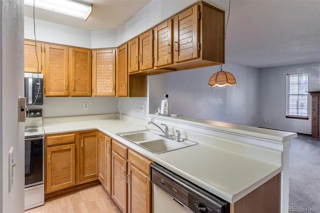a kitchen with a sink a stove and cabinets