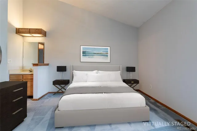 a bedroom with a bed and a lamp on table