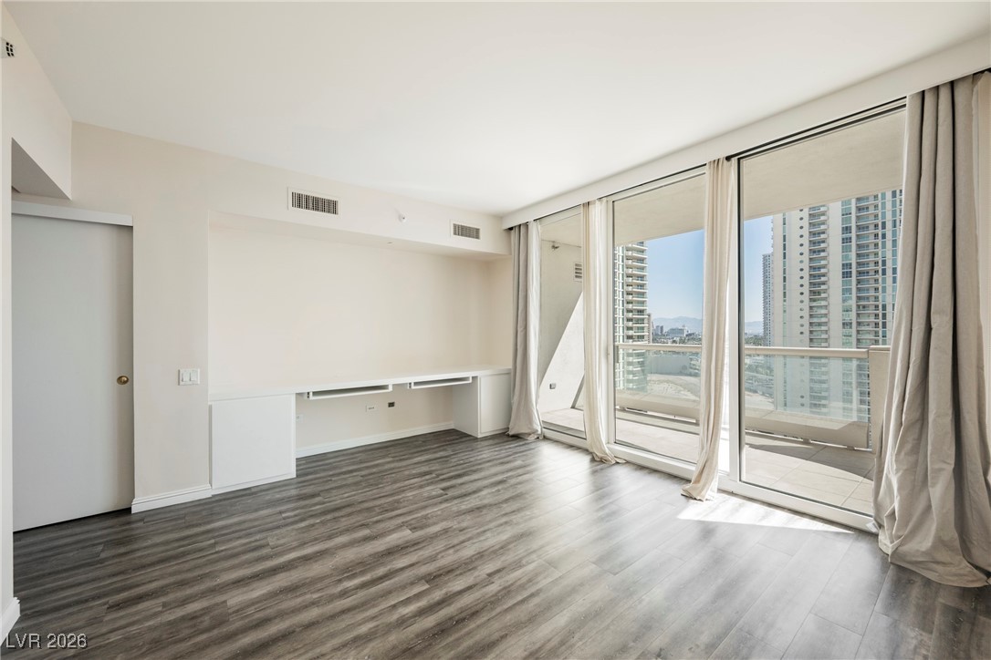 2877 Paradise Road, Unit 1604 Las Vegas, NV 89109 - Photo 17 of 47 Spare room with wood finished floors, a city view, and expansive windows