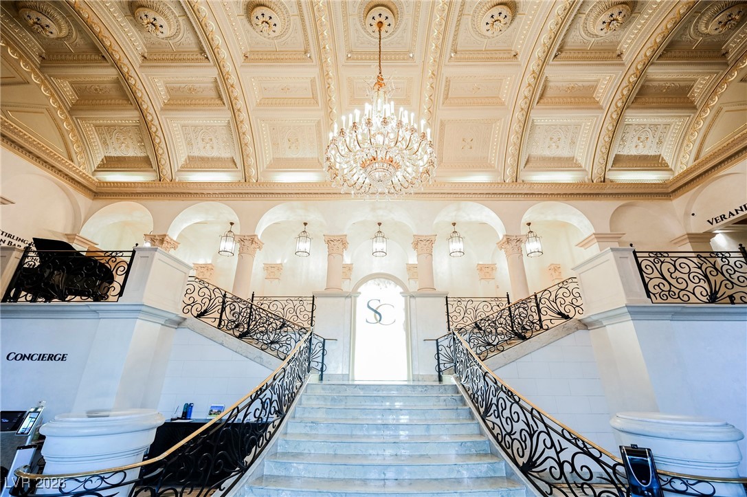2877 Paradise Road, Unit 1604 Las Vegas, NV 89109 - Photo 3 of 47 Stairs featuring a chandelier, crown molding, and a towering ceiling